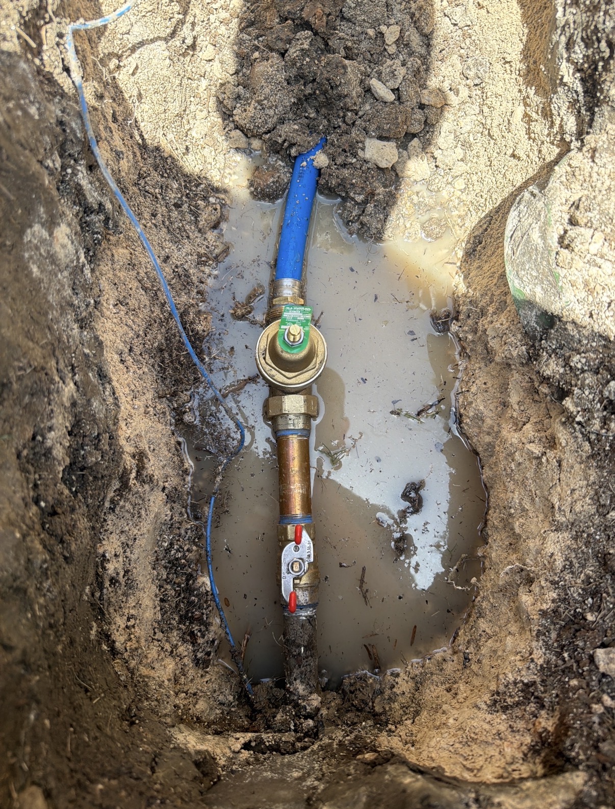 Underground brass pressure reducing valve (PRV) and main water shutoff installation in Austin, TX, by PlumbAZING.